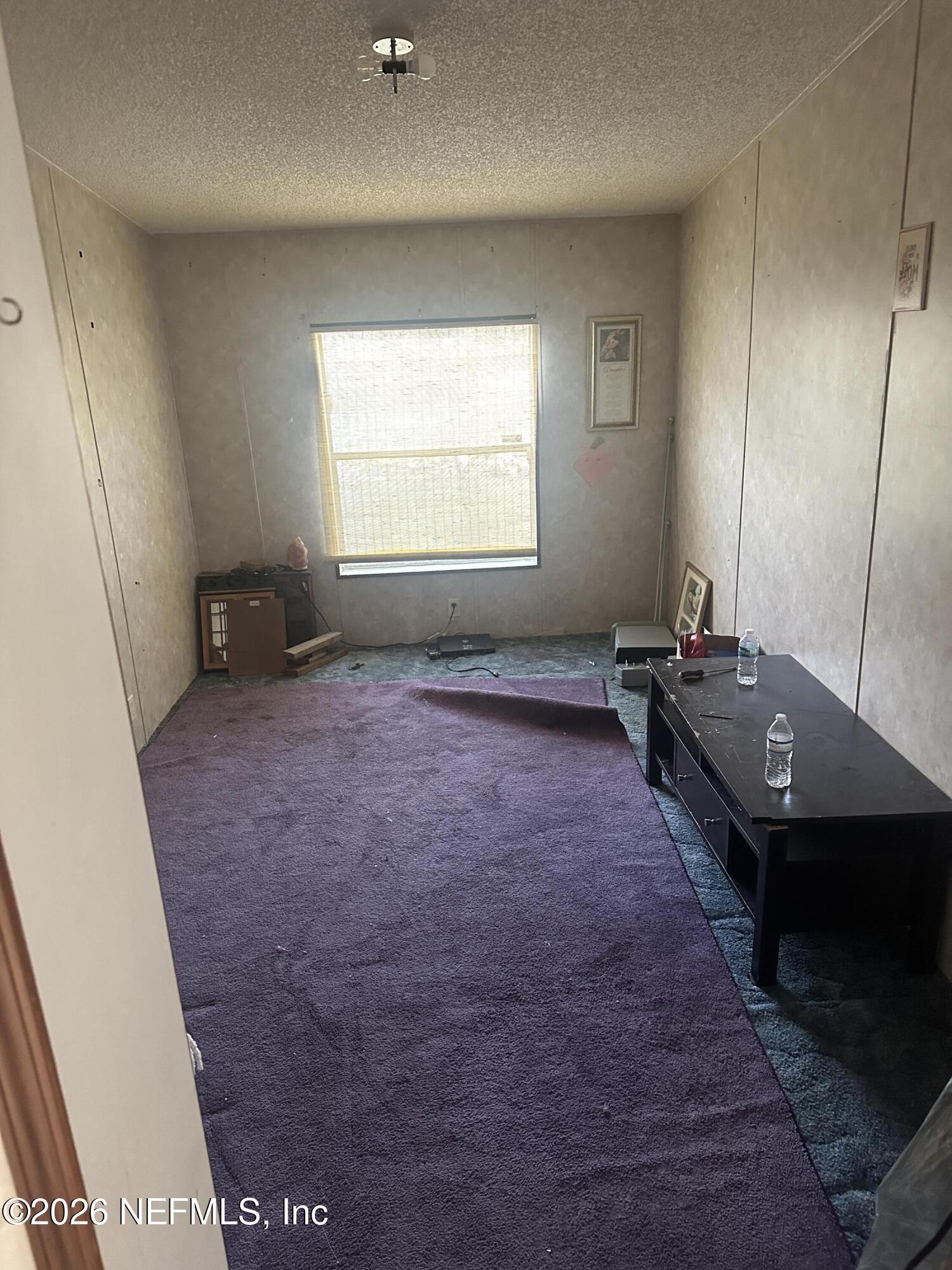 10269 Grayson Street Jacksonville, FL 32220 - Photo 8 of 9 an empty room with a window