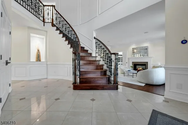 a living room with furniture a fireplace and a wooden floor