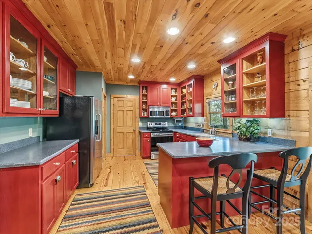 a kitchen with stainless steel appliances granite countertop a sink and cabinets