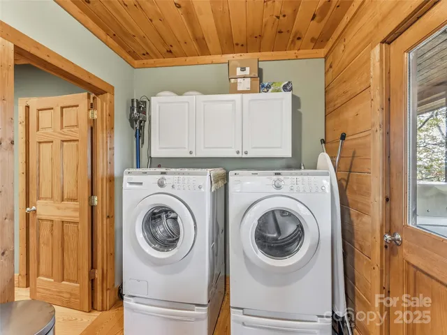 a bed sitting in a spacious bedroom next to a window