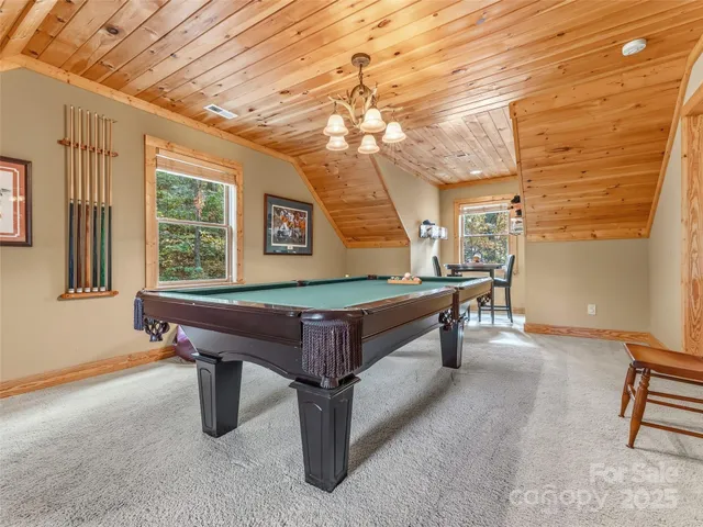 a view of a room with lots of furniture and windows