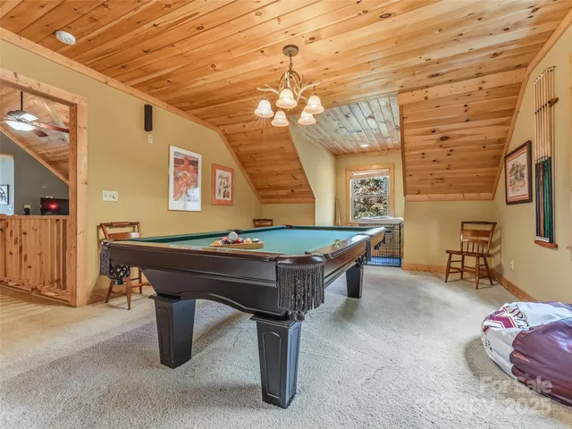 a view of a hallway with wooden floor and a potted plant