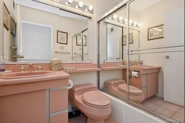 a bathroom with a sink a toilet and mirror