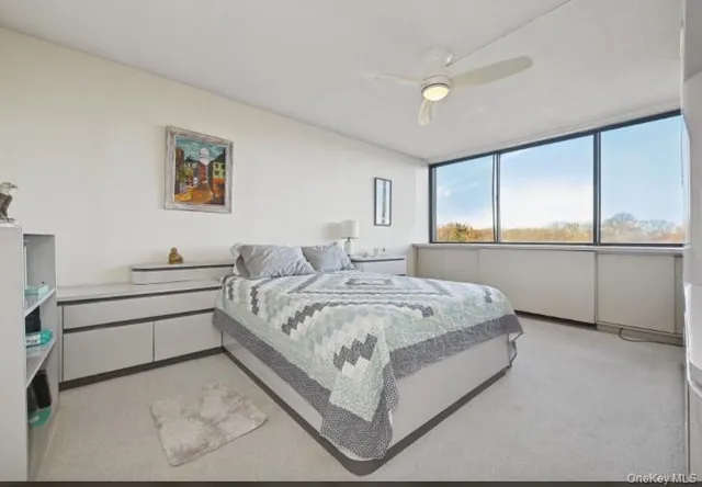 a spacious bedroom with a bed and window