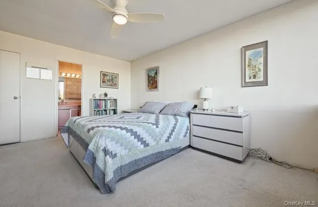 a bed room with a bed and a night stand