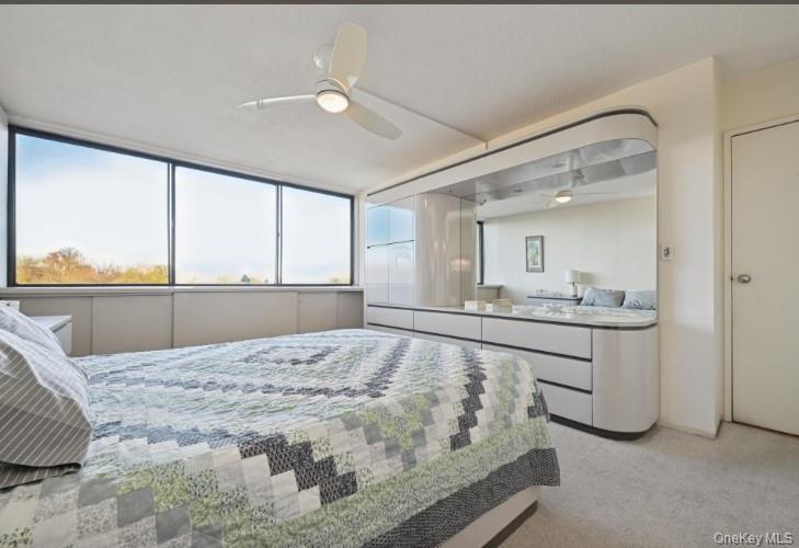 1 Bay Club Drive, Unit 6V Queens, NY 11360 - Photo 14 of 21 a bedroom with a bed and a large window with outer view