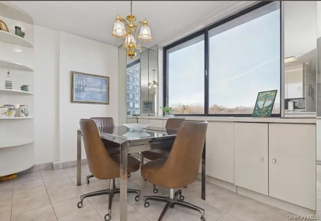 a view of a dining room with furniture and a chandelier