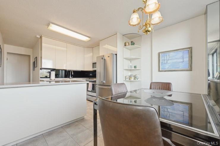 1 Bay Club Drive, Unit 6V Queens, NY 11360 - Photo 8 of 21 a kitchen with cabinets a sink and appliances