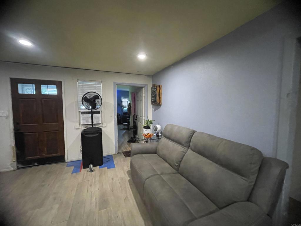 9141-43 Campo Road Spring Valley, CA 91977 - Photo 14 of 26 a living room with furniture and a wooden floor