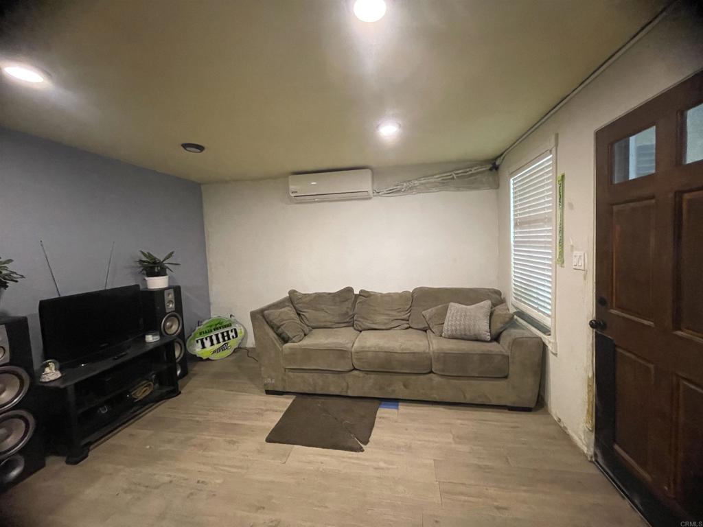 9141-43 Campo Road Spring Valley, CA 91977 - Photo 15 of 26 a living room with furniture a flat screen tv and a fireplace