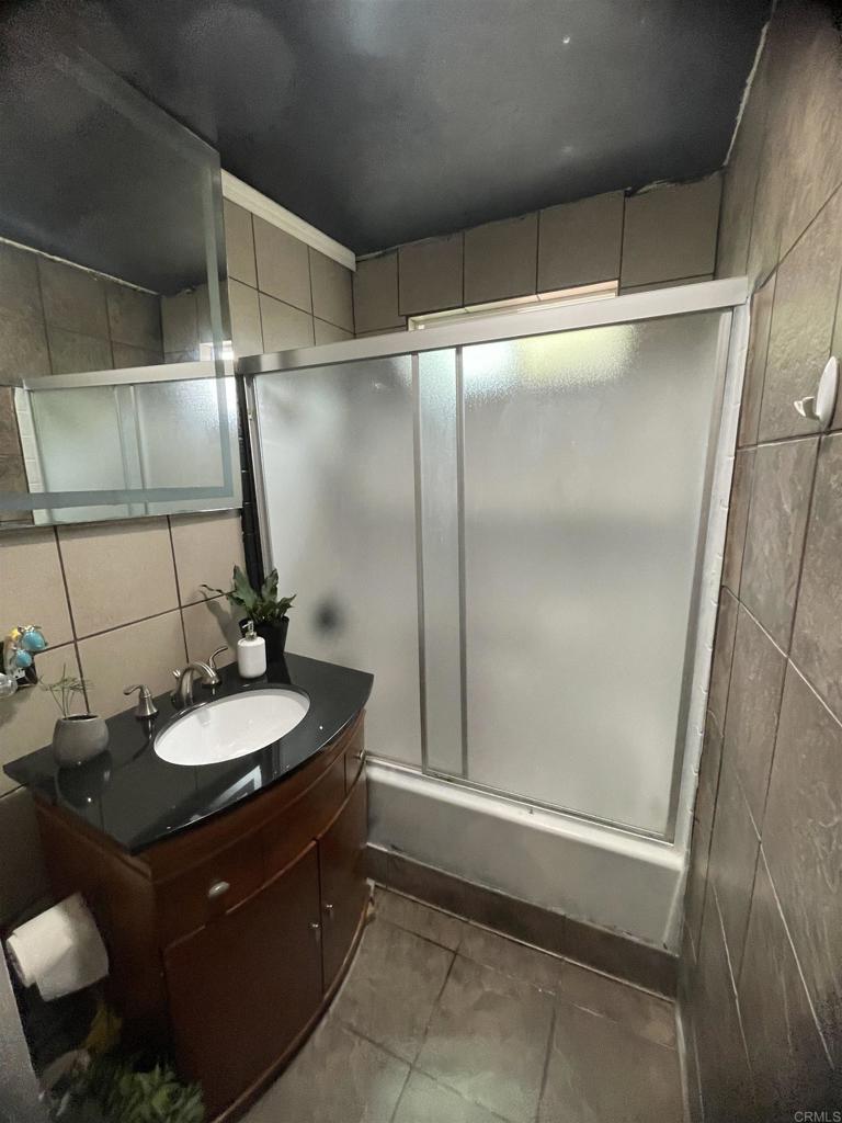 9141-43 Campo Road Spring Valley, CA 91977 - Photo 19 of 26 a bathroom with a sink and a mirror