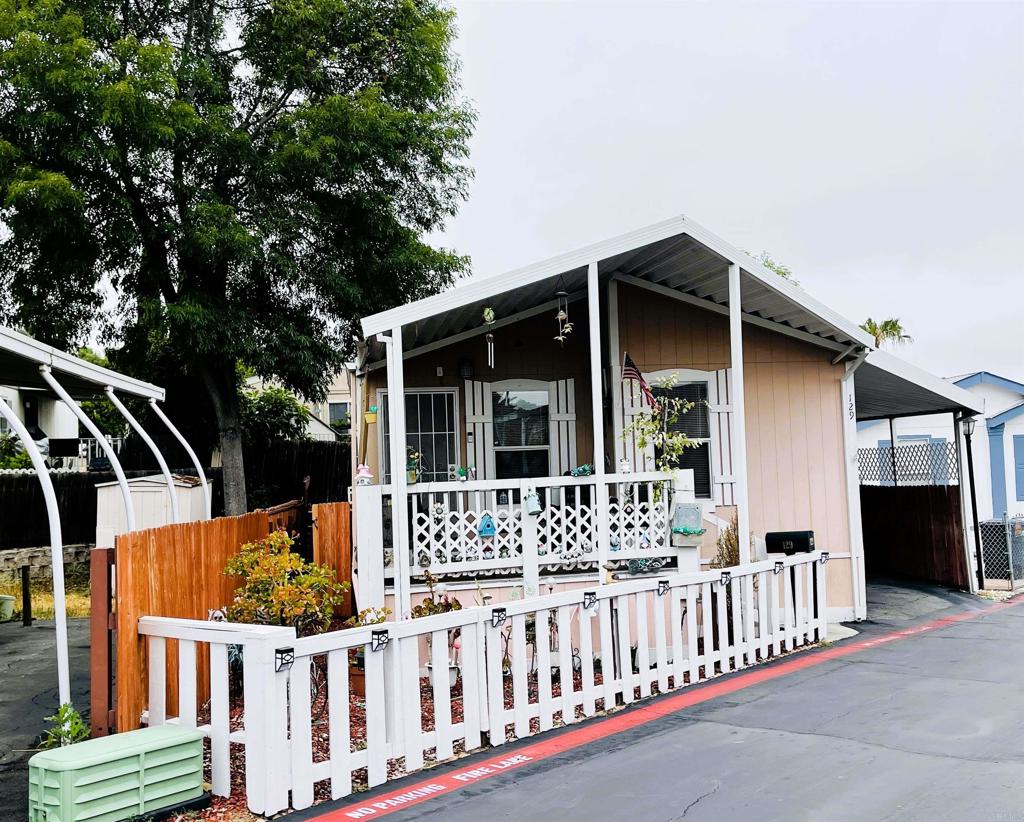 a view of a house with wooden fence