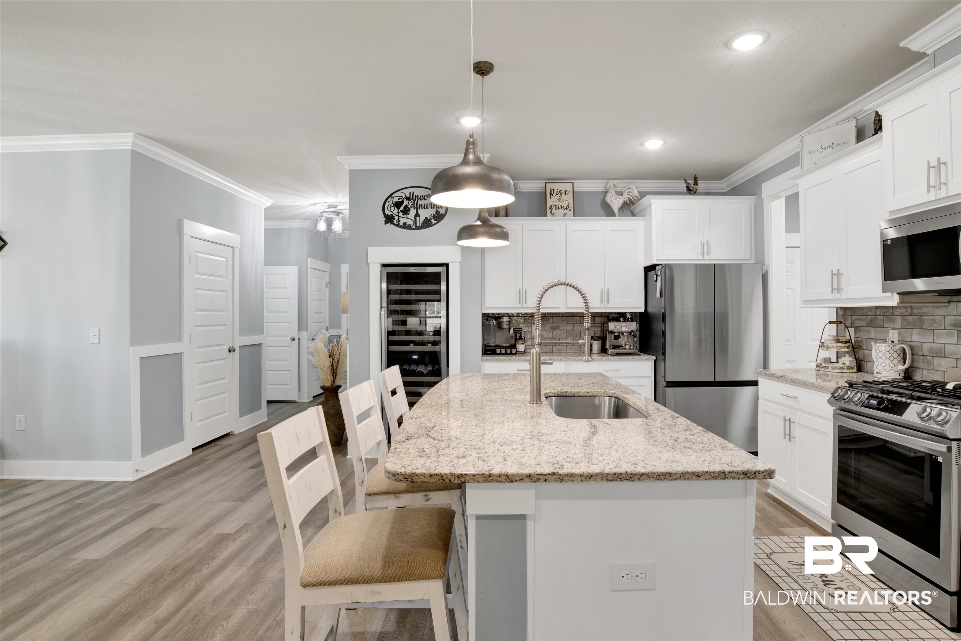 10113 Lakeview Drive Foley, AL 36535 - Photo 12 of 34 Kitchen with appliances with stainless steel finishes, hanging light fixtures, sink, and light stone counters