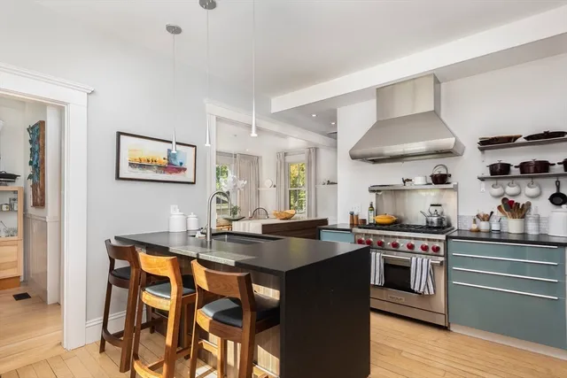 a kitchen with stainless steel appliances granite countertop a stove and a sink