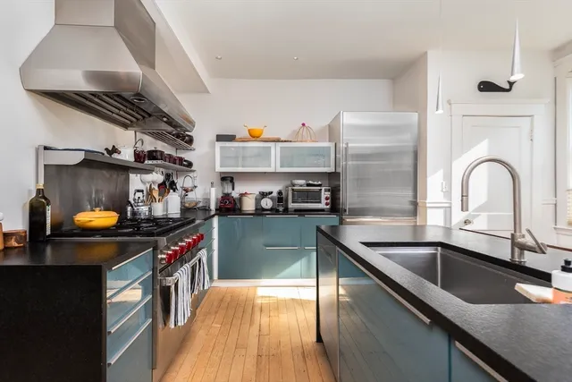 a kitchen that has a sink and a stove