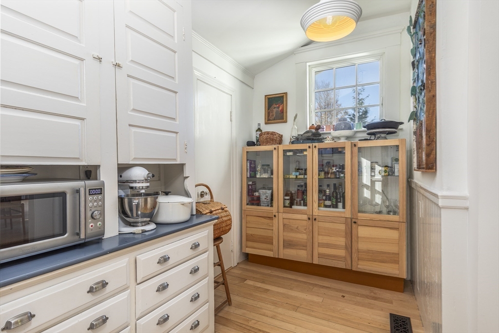 4 Ballast Lane Marblehead, MA 01945 - Photo 15 of 42 a kitchen with stainless steel appliances kitchen island granite countertop a sink and cabinets