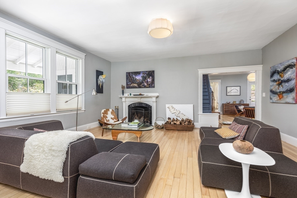 4 Ballast Lane Marblehead, MA 01945 - Photo 18 of 42 a living room with furniture a fireplace and a large window