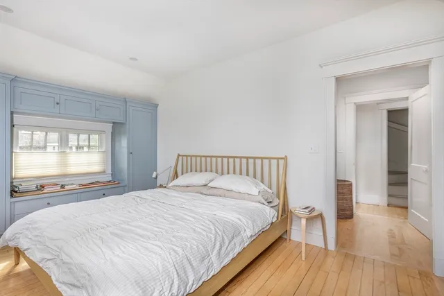 a large bed sitting in a bedroom next to a window