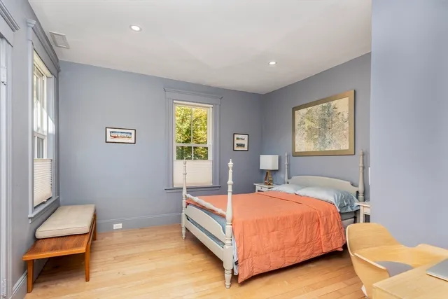 a bedroom with a bed and window