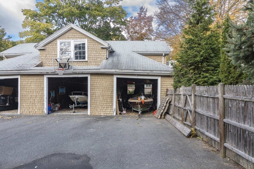 4 Ballast Lane Marblehead, MA 01945 - Photo 39 of 42 a view of a house with large windows and a small yard
