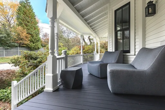 a view of balcony with furniture and wooden floor