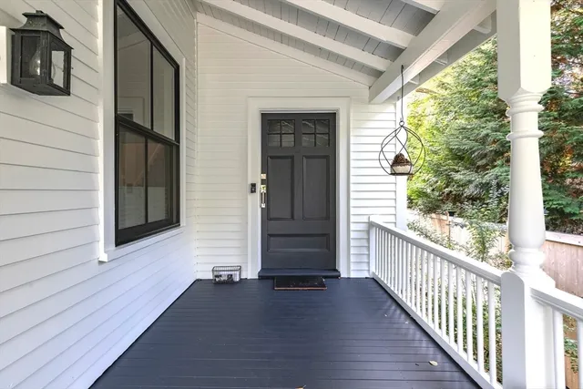 a view of a porch with wooden floor and stairs