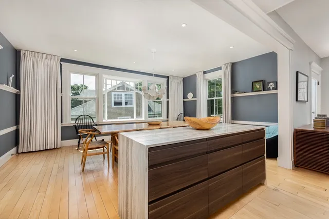a kitchen with stainless steel appliances granite countertop a stove and a wooden floors