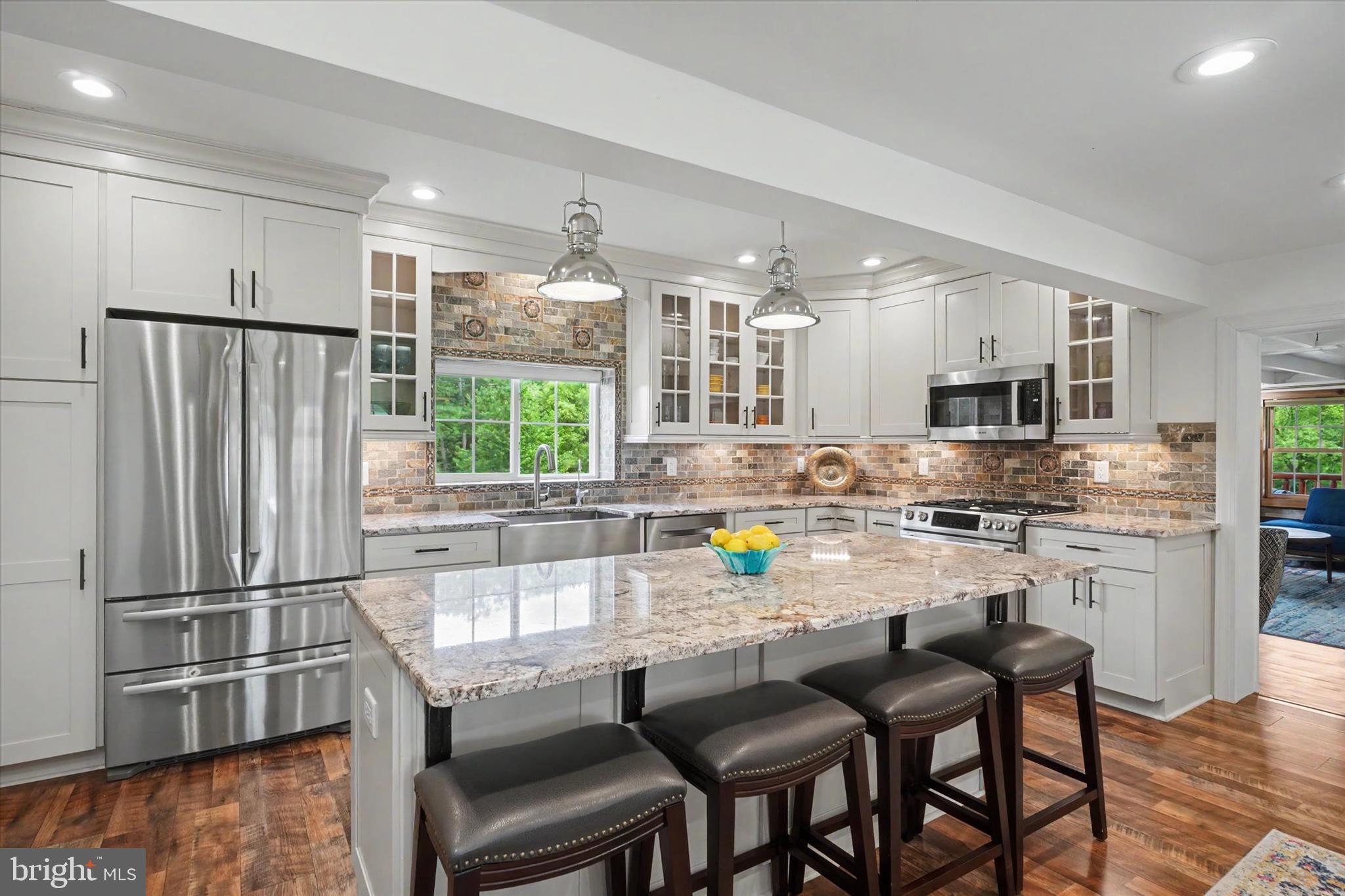 4941 Walters Hatchery Road Spring Grove, PA 17362 - Photo 47 of 71 a kitchen with stainless steel appliances a dining table chairs refrigerator and sink