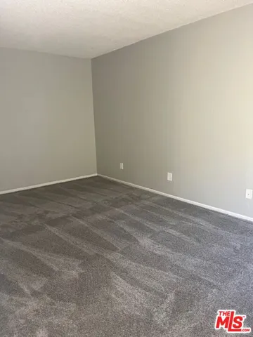 a bathroom with a granite countertop sink toilet and mirror