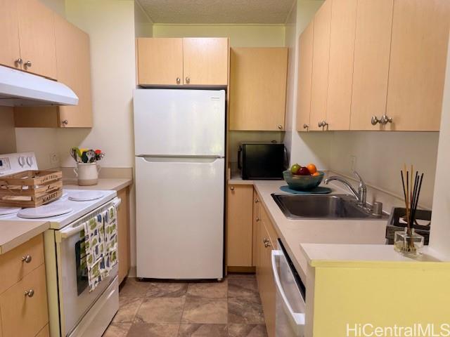 3161 Ala Ilima Street, Unit 107 Honolulu, HI 96818 - Photo 12 of 23 a kitchen with a refrigerator a stove a washer and dryer