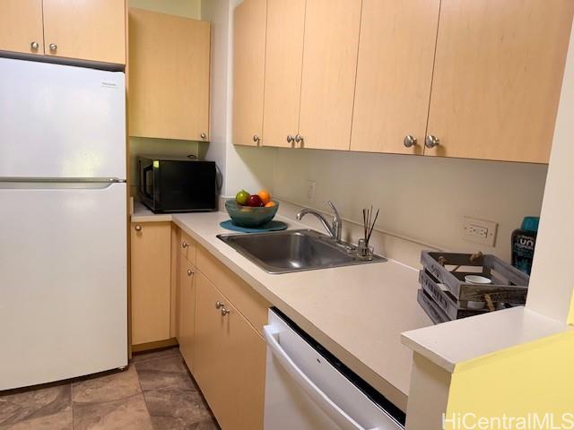 3161 Ala Ilima Street, Unit 107 Honolulu, HI 96818 - Photo 13 of 23 a kitchen with a sink a stove and a refrigerator