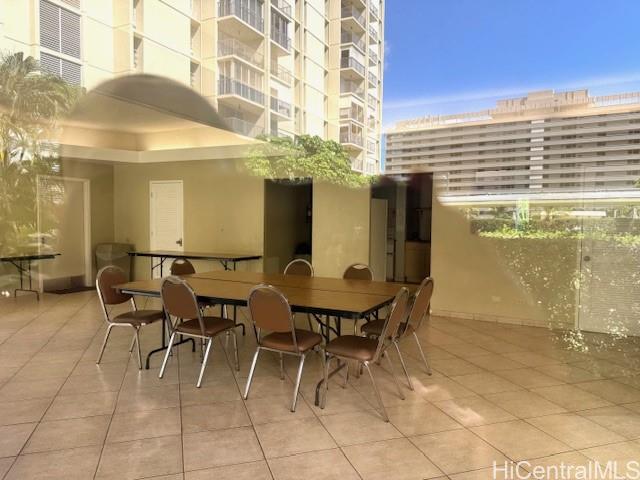 3161 Ala Ilima Street, Unit 107 Honolulu, HI 96818 - Photo 13 of 18 a view of a patio with dining table and chairs