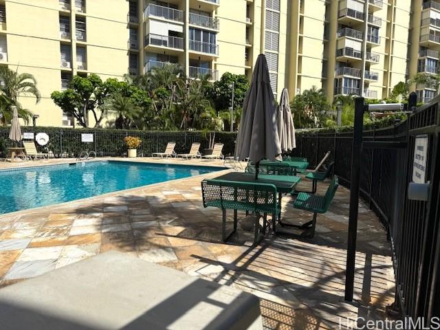 3161 Ala Ilima Street, Unit 107 Honolulu, HI 96818 - Photo 14 of 18 a view of swimming pool with outdoor seating and plants