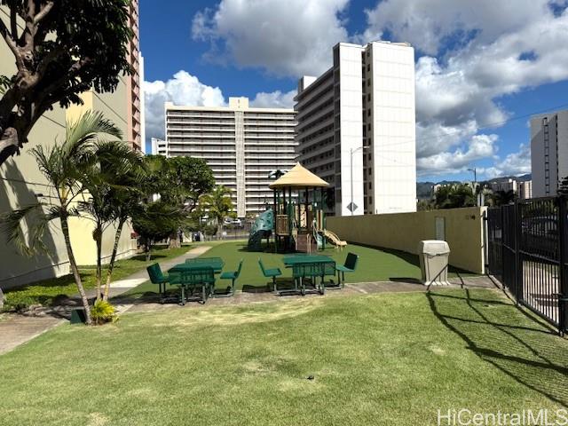 3161 Ala Ilima Street, Unit 107 Honolulu, HI 96818 - Photo 18 of 18 a view of backyard with table and chairs and potted plants