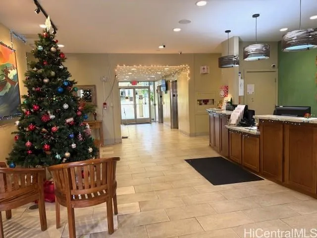 a lobby with furniture and a potted plants