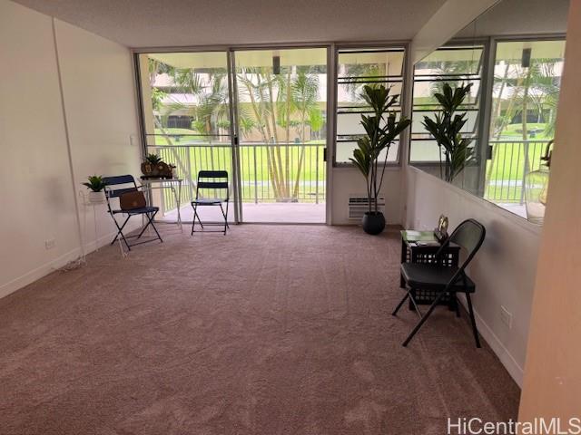 3161 Ala Ilima Street, Unit 107 Honolulu, HI 96818 - Photo 9 of 23 a living room with furniture and a floor to ceiling window