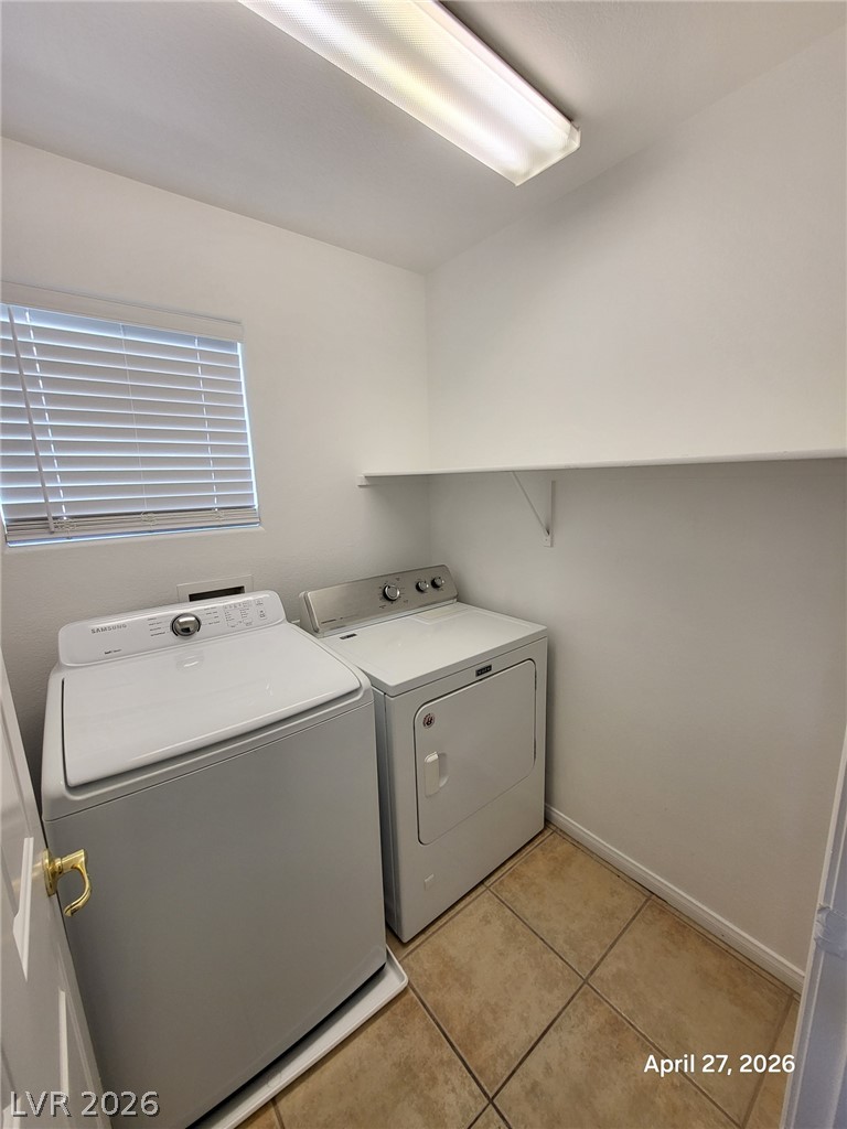 4548 Flaming Ridge Trail Las Vegas, NV 89147 - Photo 9 of 21 Functional tile flooring and a built-in shelf complete this practical dedicated laundry space.