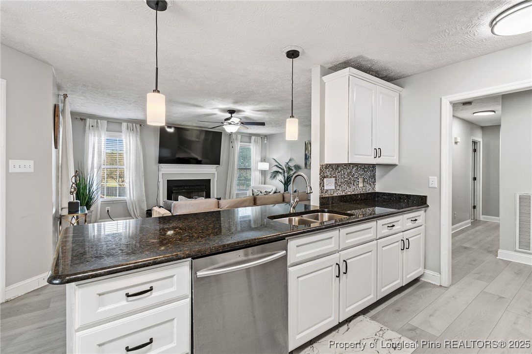 780 Wayside Road Raeford, NC 28376 - Photo 13 of 37 a kitchen with stainless steel appliances granite countertop a sink a stove and a granite counter tops