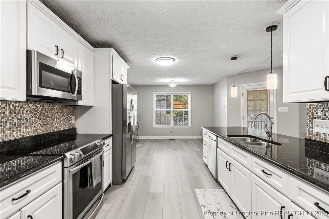 780 Wayside Road Raeford, NC 28376 - Photo 17 of 37 a kitchen with stainless steel appliances kitchen island granite countertop a stove and a sink