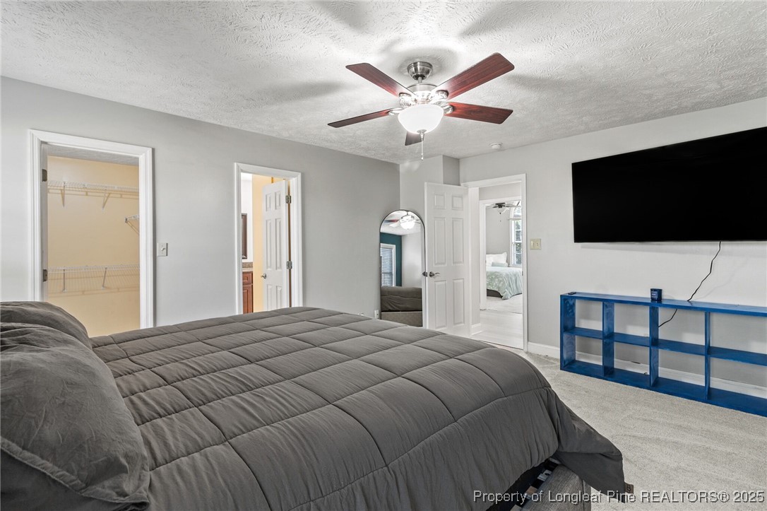 780 Wayside Road Raeford, NC 28376 - Photo 19 of 37 a bedroom with a large bed and a flat screen tv