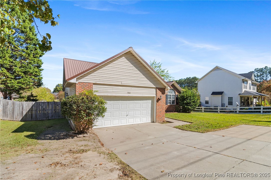 780 Wayside Road Raeford, NC 28376 - Photo 2 of 37 a view of a house with a yard and potted plants