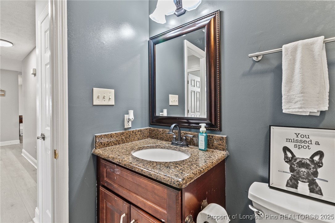 780 Wayside Road Raeford, NC 28376 - Photo 26 of 37 a bathroom with a granite countertop sink and a mirror