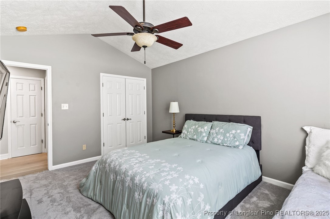 780 Wayside Road Raeford, NC 28376 - Photo 28 of 37 a bedroom with a bed and a chandelier