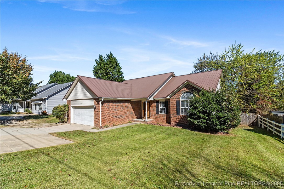 780 Wayside Road Raeford, NC 28376 - Photo 3 of 37 a view of a house with a big yard plants and large trees