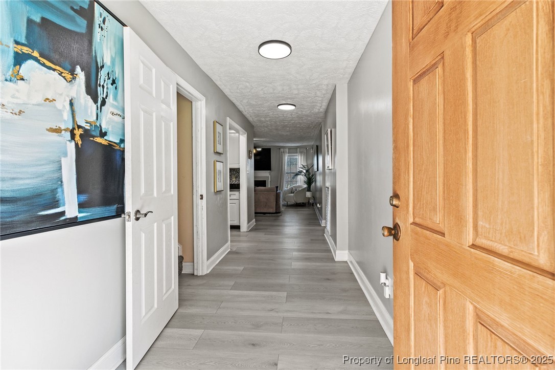780 Wayside Road Raeford, NC 28376 - Photo 5 of 37 a view of a hallway with wooden floor and staircase