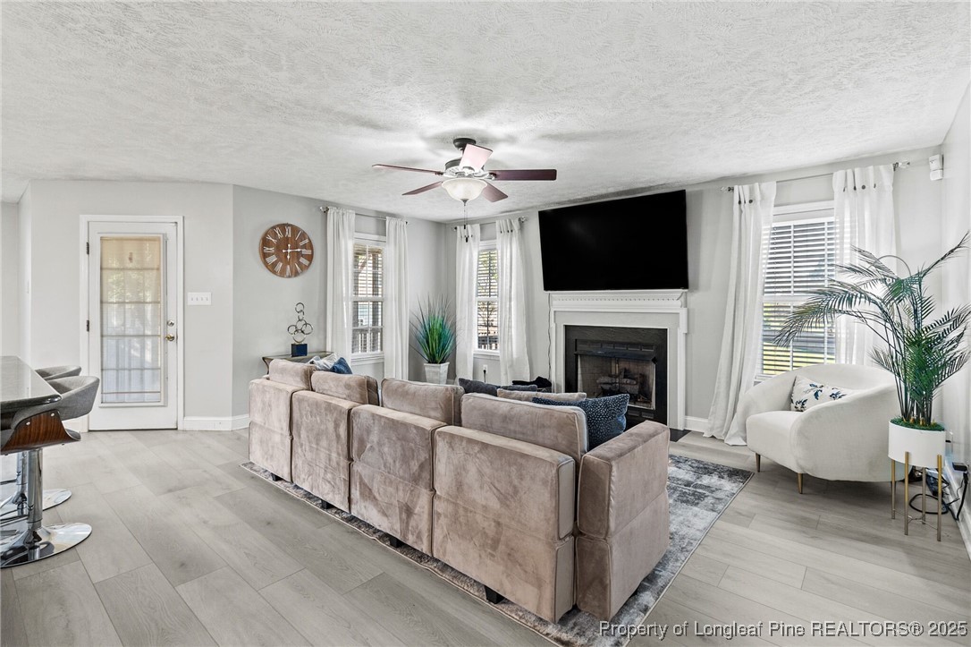 780 Wayside Road Raeford, NC 28376 - Photo 6 of 37 a living room with furniture a flat screen tv and a fireplace