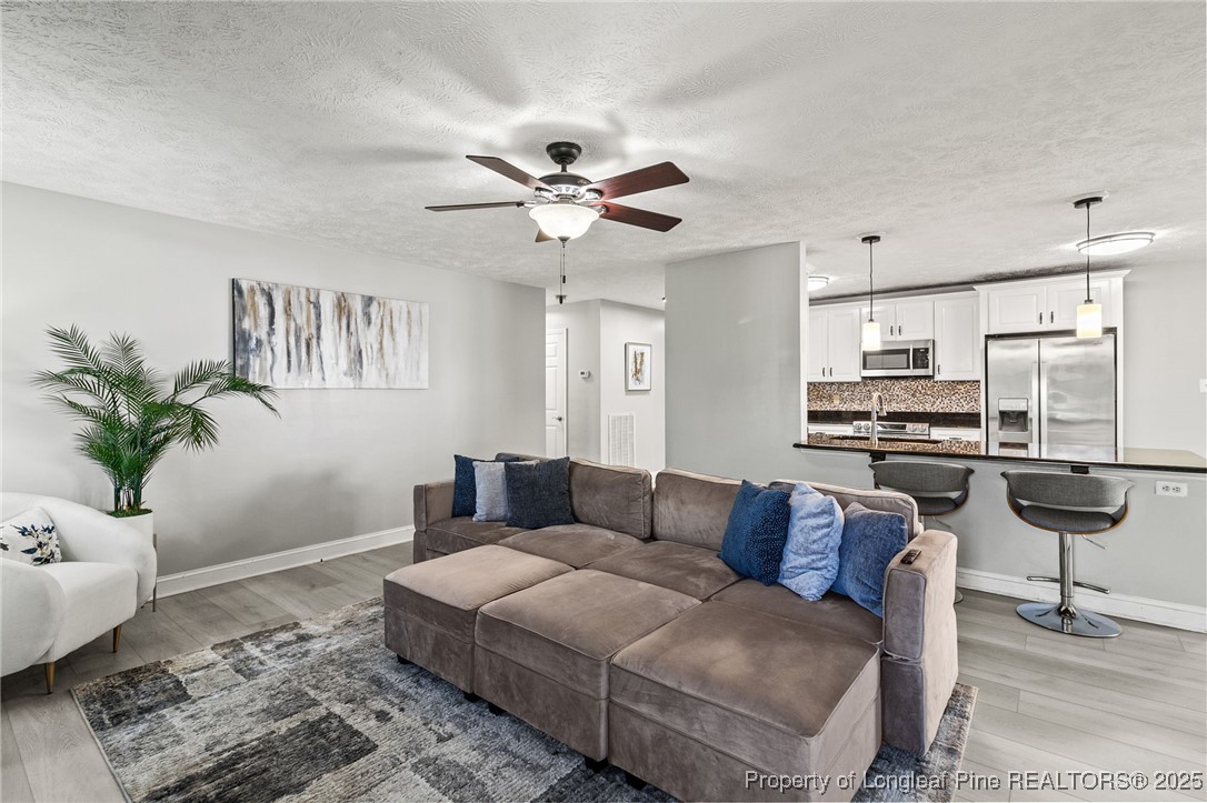 780 Wayside Road Raeford, NC 28376 - Photo 8 of 37 a living room with furniture and kitchen view
