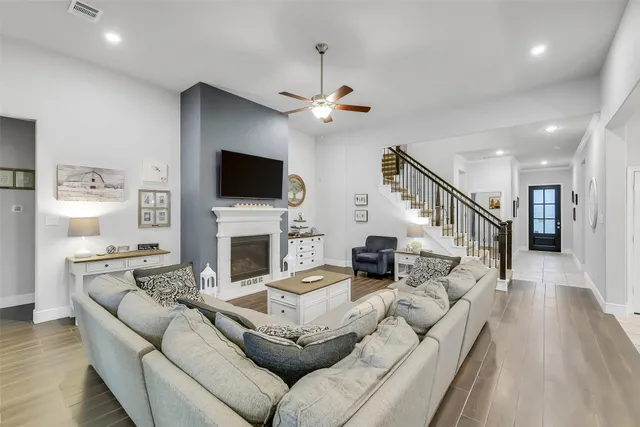 a living room with furniture a fireplace and a flat screen tv