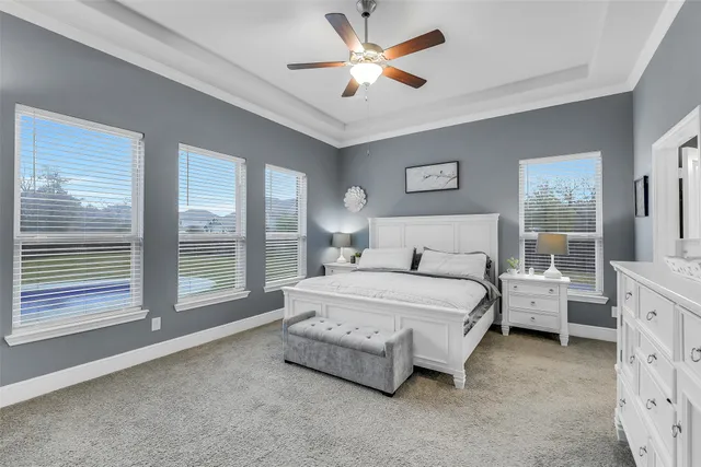 a spacious bedroom with a bed and a large window