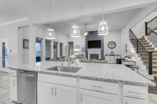 a bathroom with a granite countertop double vanity sink and a mirror